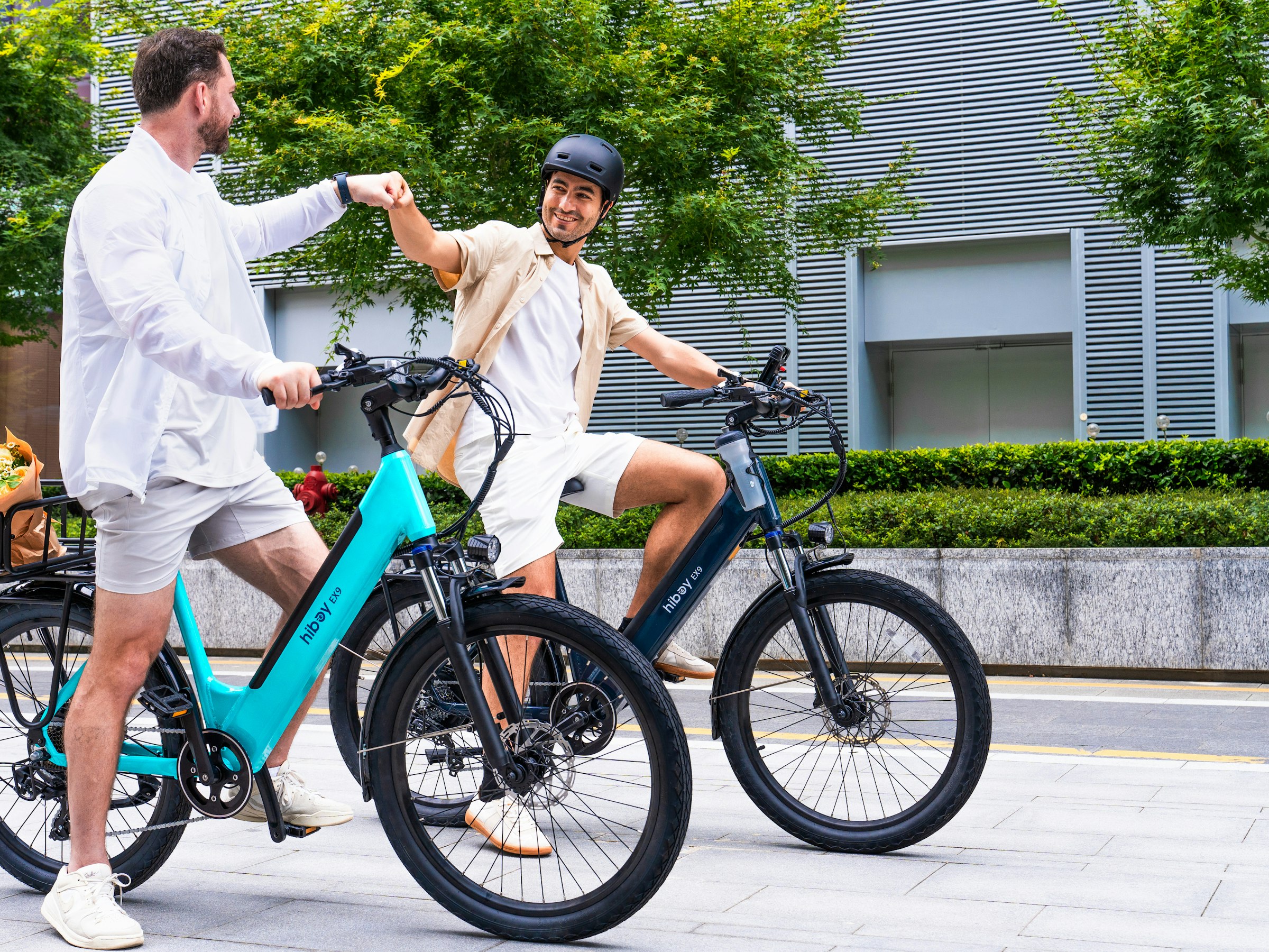 Two riders on electric bikes outdoors on a long-distance ride